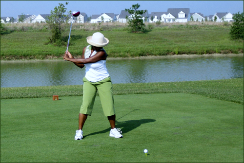 Margo takes a swing on the Heritage Shores Golf Course in Bridgeville DE