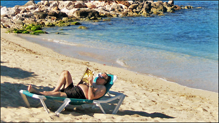 Man reads on vacation at the Flamingo Beach Resort in St. Maarten.  Photo by E.W. Faircloth