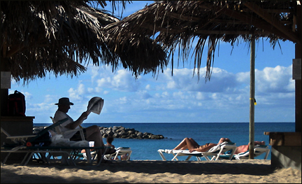 Man reads on vacation at the Flamingo Beach Resort in St. Maarten.  Photo by E.W. Faircloth